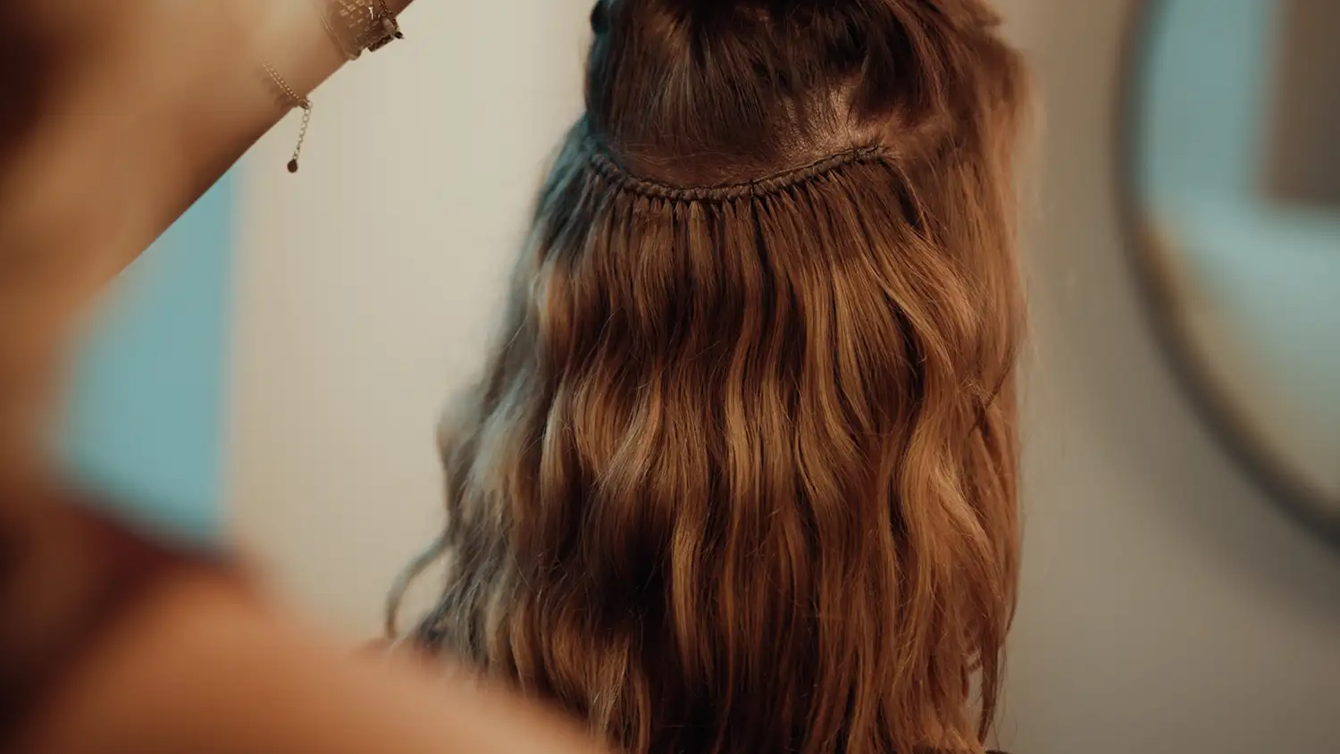 Stylist working on a Cèlia Blu hair weft in the salon
